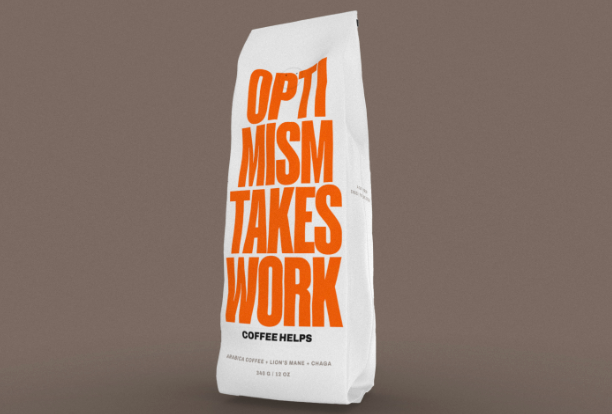 Photo of a coffee bag emblazoned with OPTIMISM TAKES WORK. COFFEE HELPS.