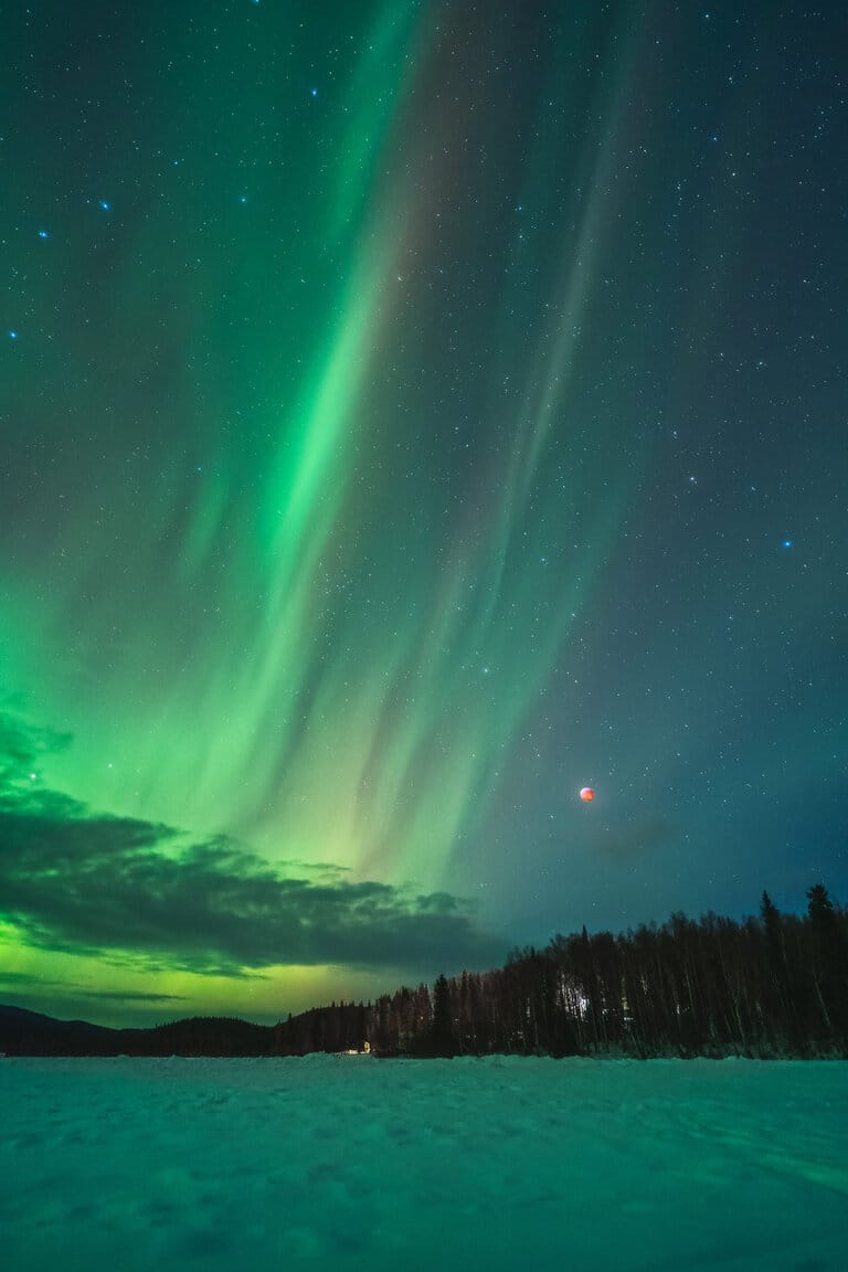 Landscape photo of the northern lights and a solar eclipse by Dan Zafra.