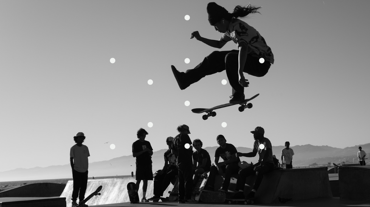 Black and white photo of a skateboarder suspended mid-air.