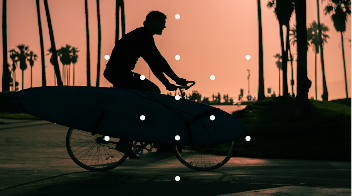 Man on a bicycle at dusk.