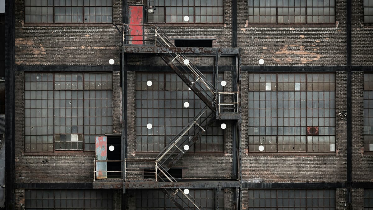 Photo of windows on a building facade with a fire escape